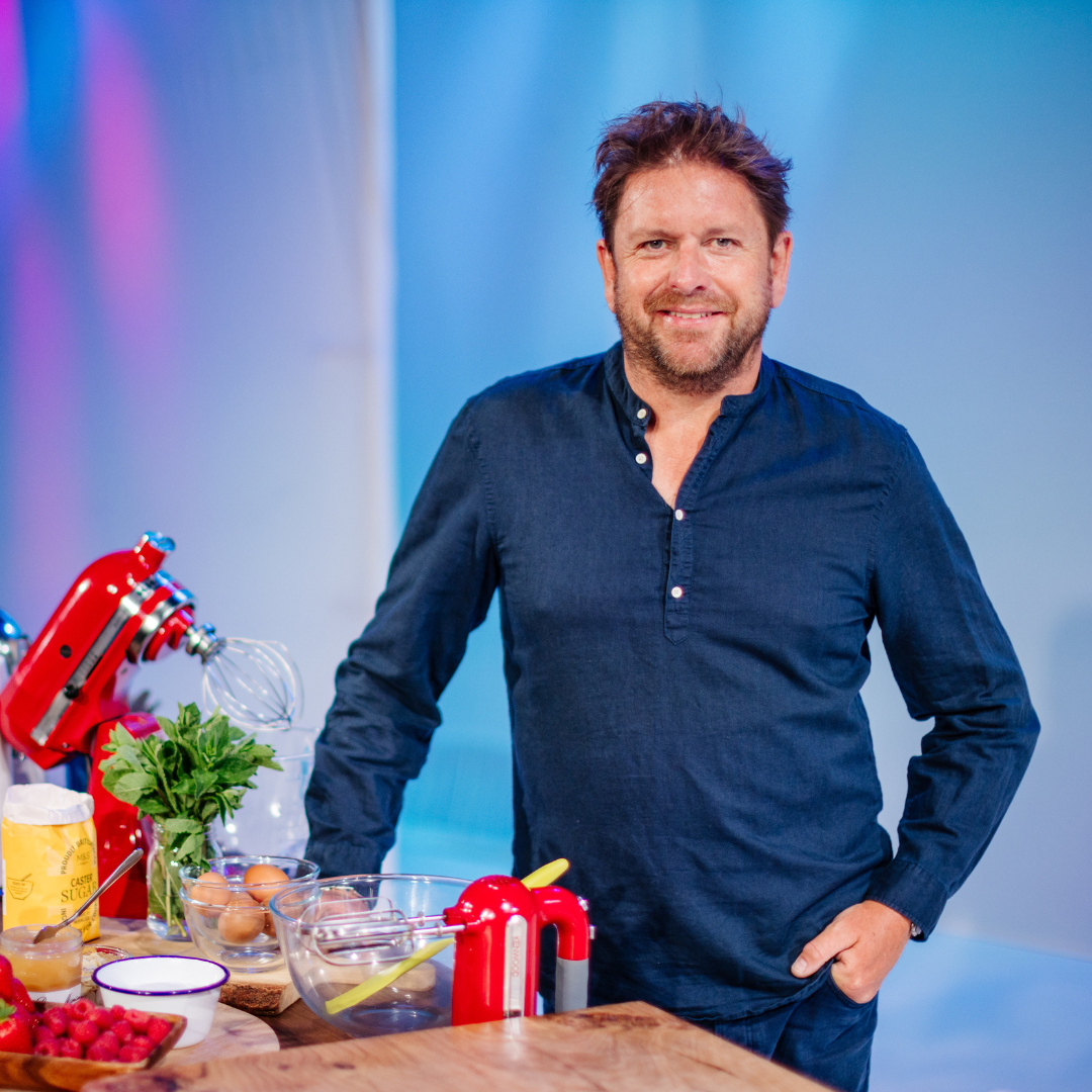 James Martin smiling onstage at the BBC Good Food Show Summer