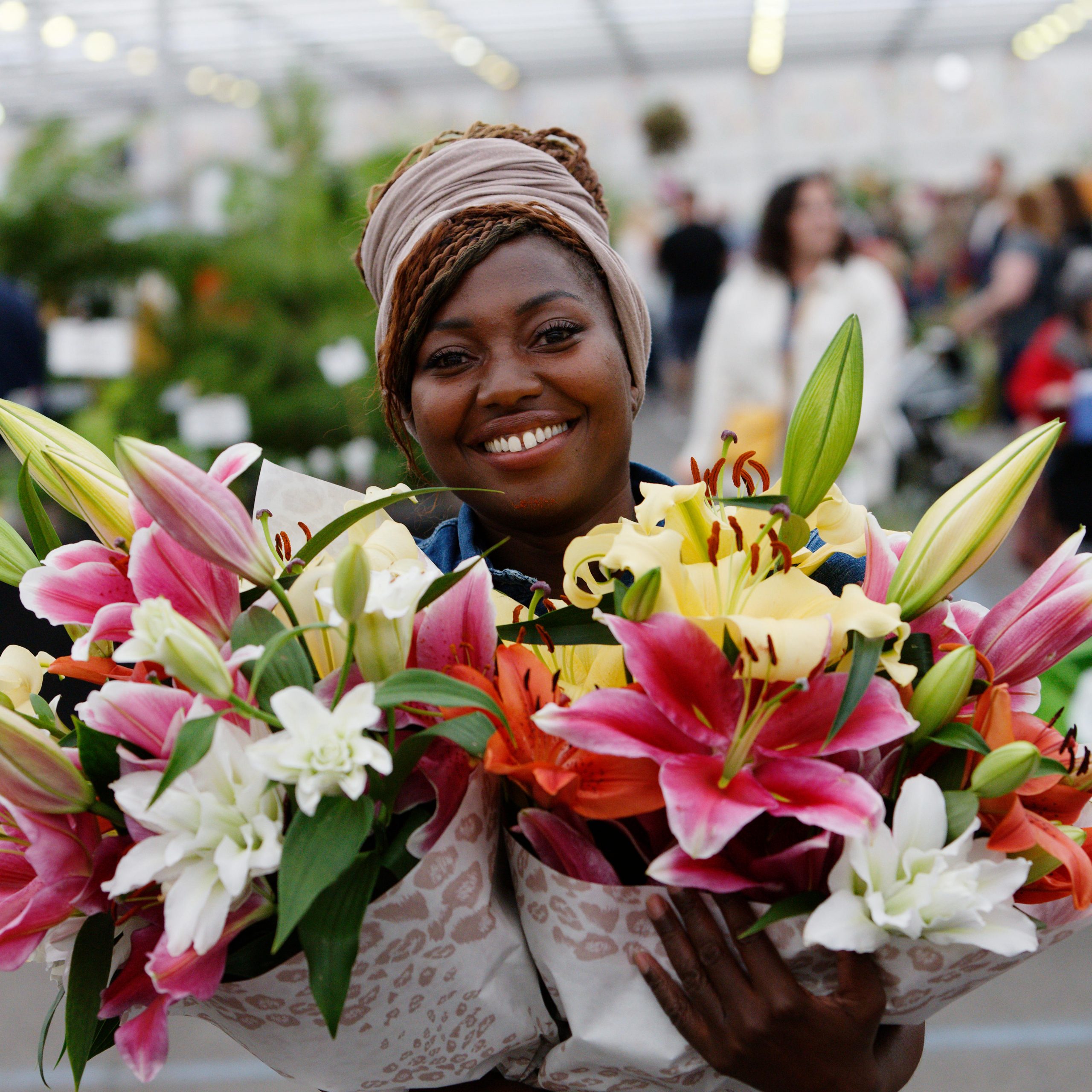 Lady carrying two bouquets of flowers at BBC Gardeners' World Live