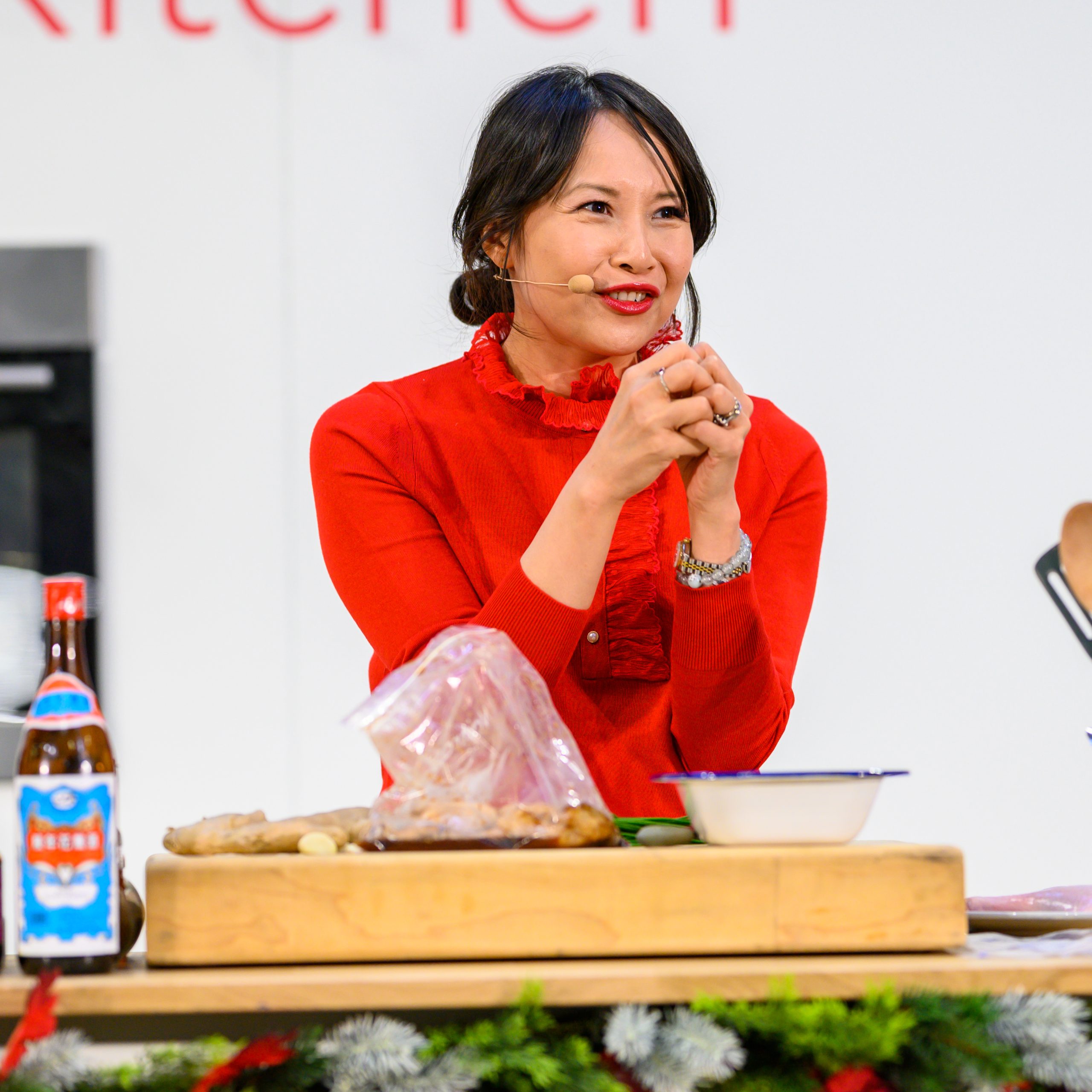 Ching-He Huang onstage with a chopping board and ingredients at BBC Good Food Show Summer