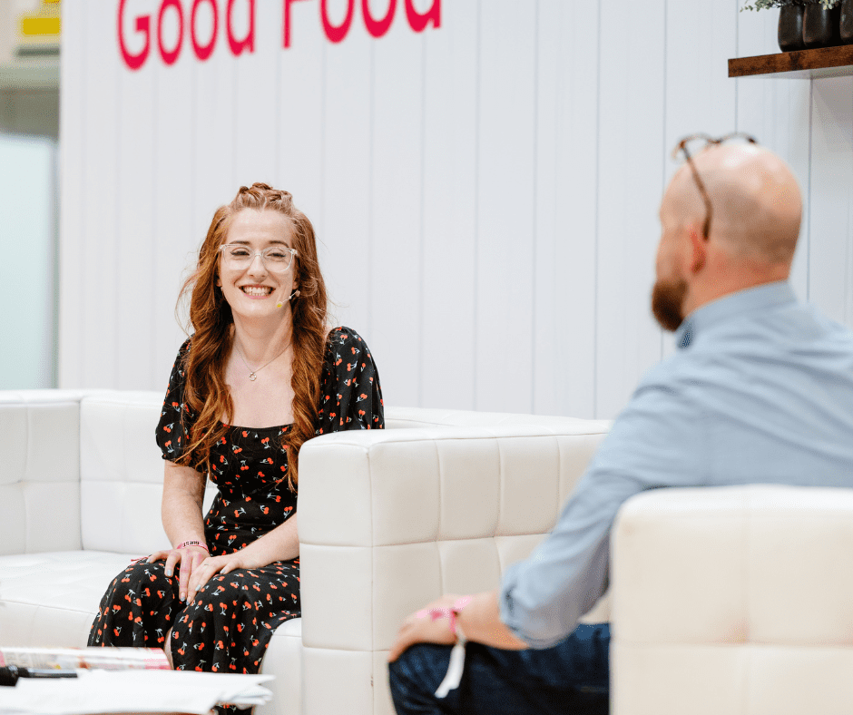 Jane Dunn of the blog 'Jane's Patisserie' smiling during a sofa-based interview with Barney