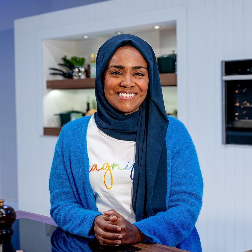 Nadiya Hussain smiling for the camera onstage at the BBC Good Food Show Summer