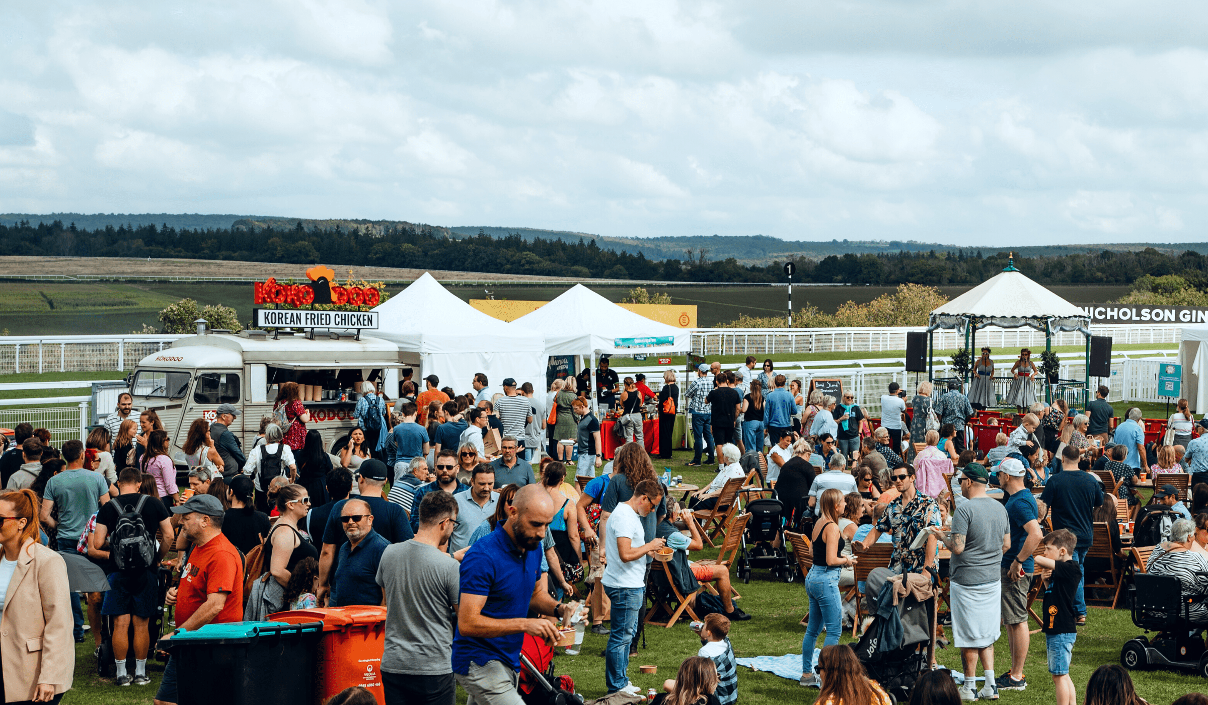 Crowd of festivalgoers alongside the race track at BBC Good Food Festival at Goodwood Racecourse